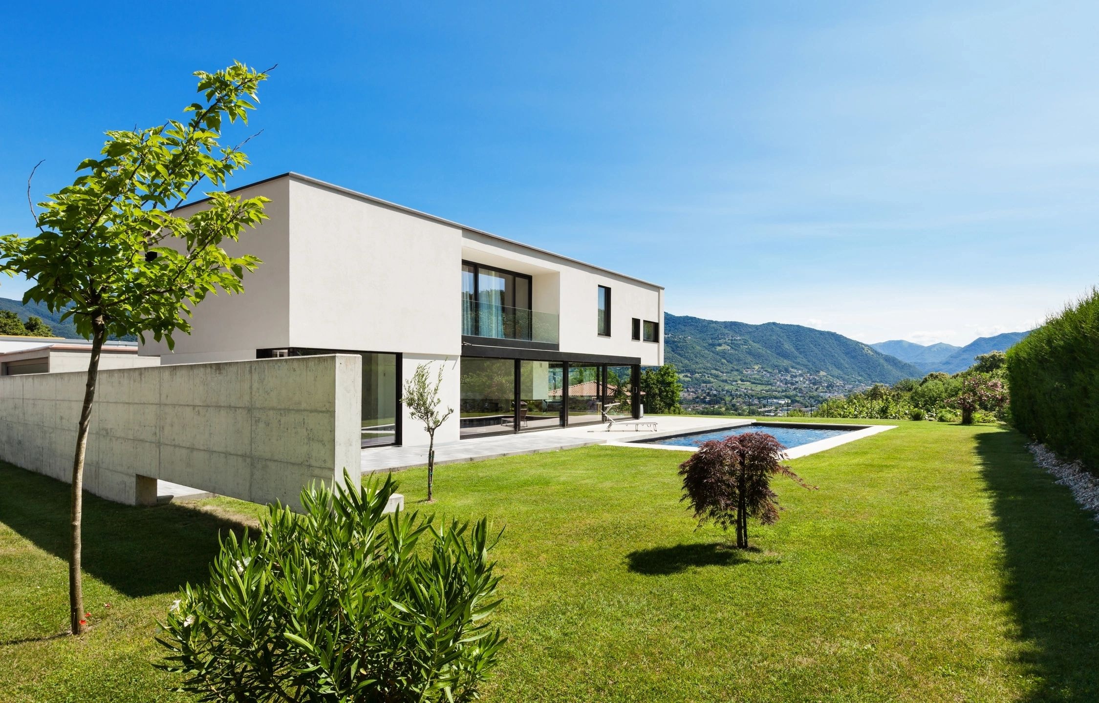 Modern white villa with pool and mountains
