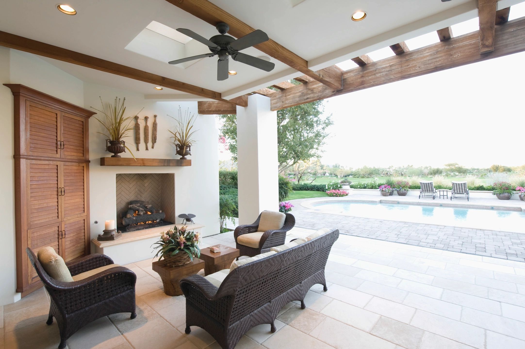 Luxury outdoor living space with fireplace and pool